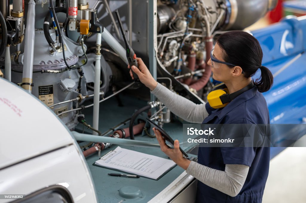 Mechanic checks car undercarriage in GMG-compliant noise-controlled workshop