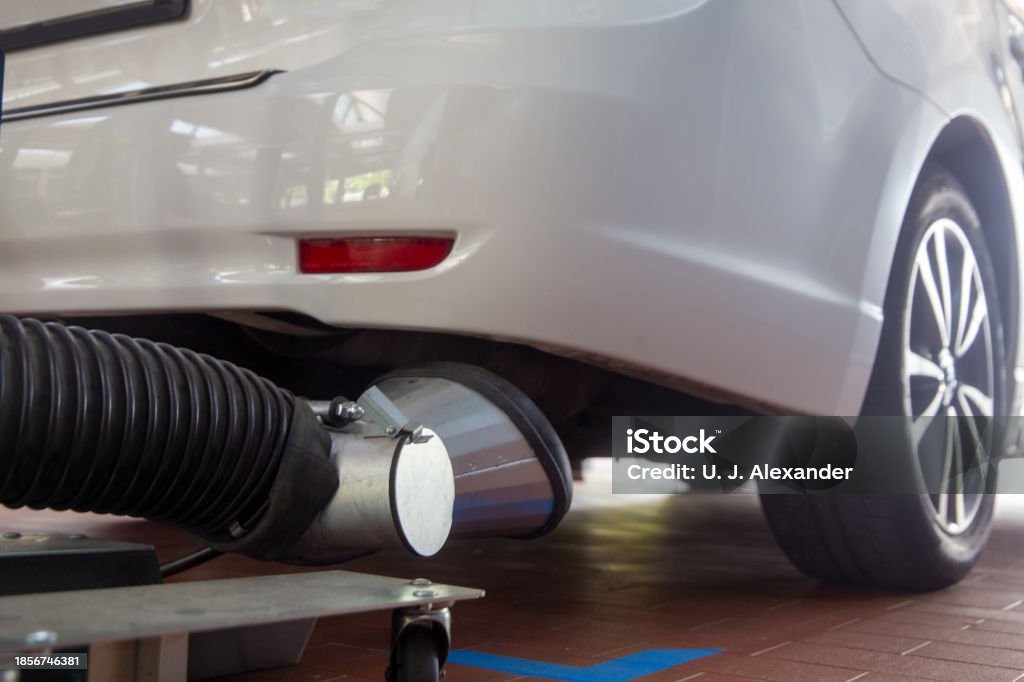 Mechanic checks car undercarriage in GMG-compliant noise-controlled workshop