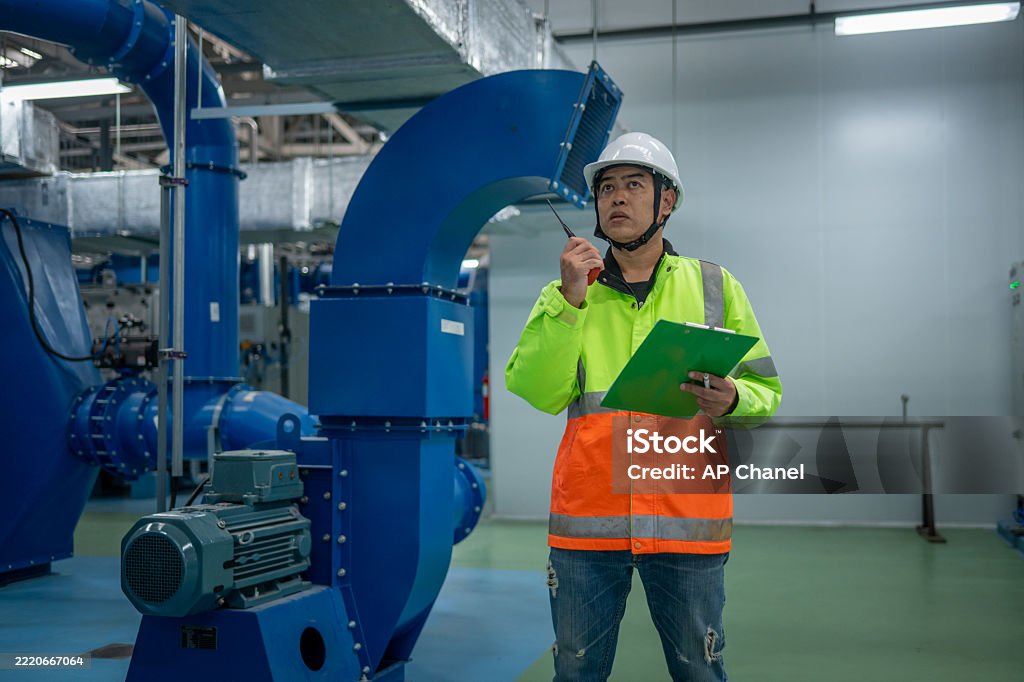 Technician in a mask smiles, breathing easy with GMG’s air quality standards