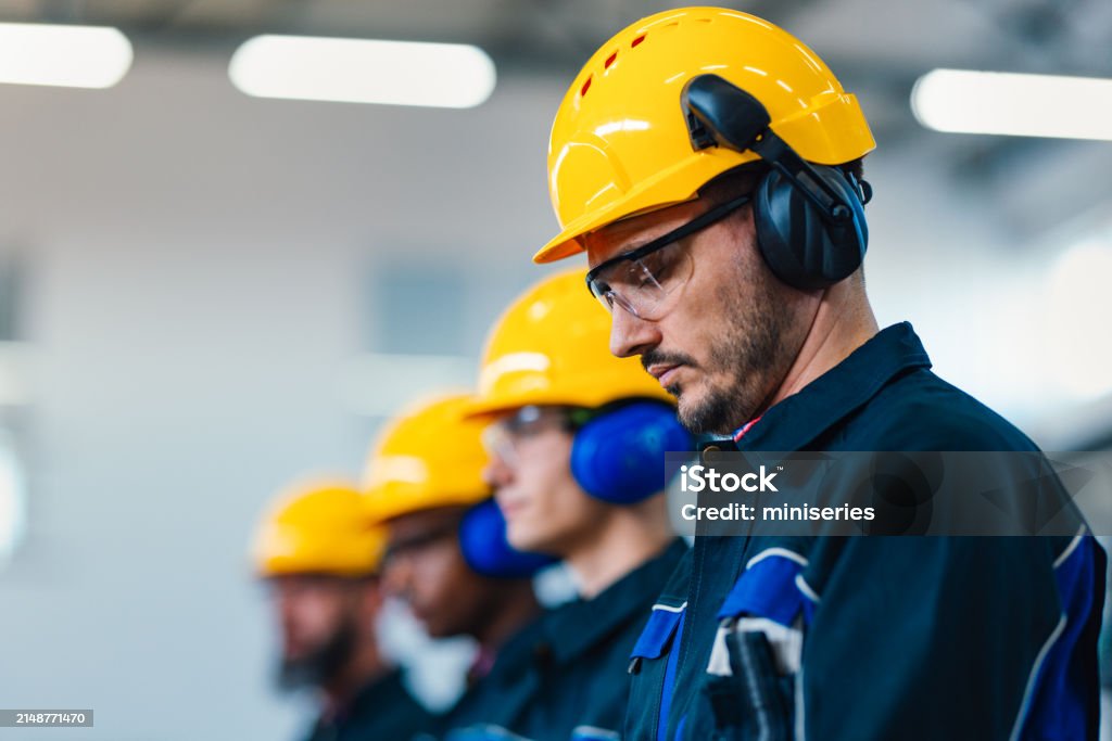Mechanic checks car undercarriage in GMG-compliant noise-controlled workshop