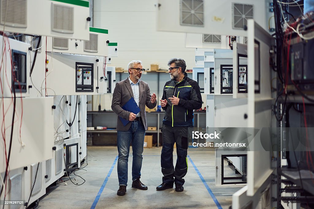 Mechanic checks car undercarriage in GMG-compliant noise-controlled workshop