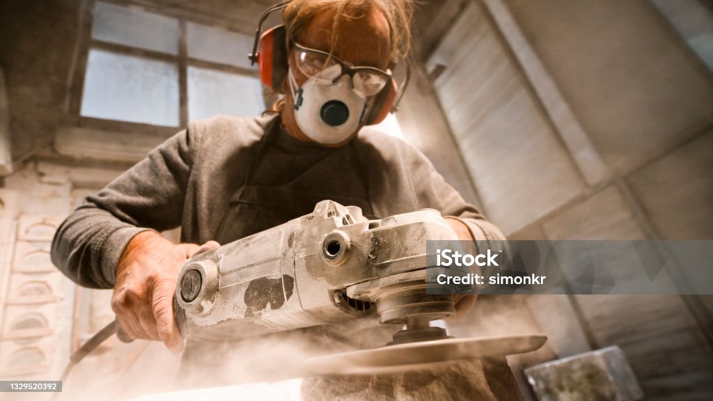 Technician in a mask smiles, breathing easy with GMG’s air quality standards
