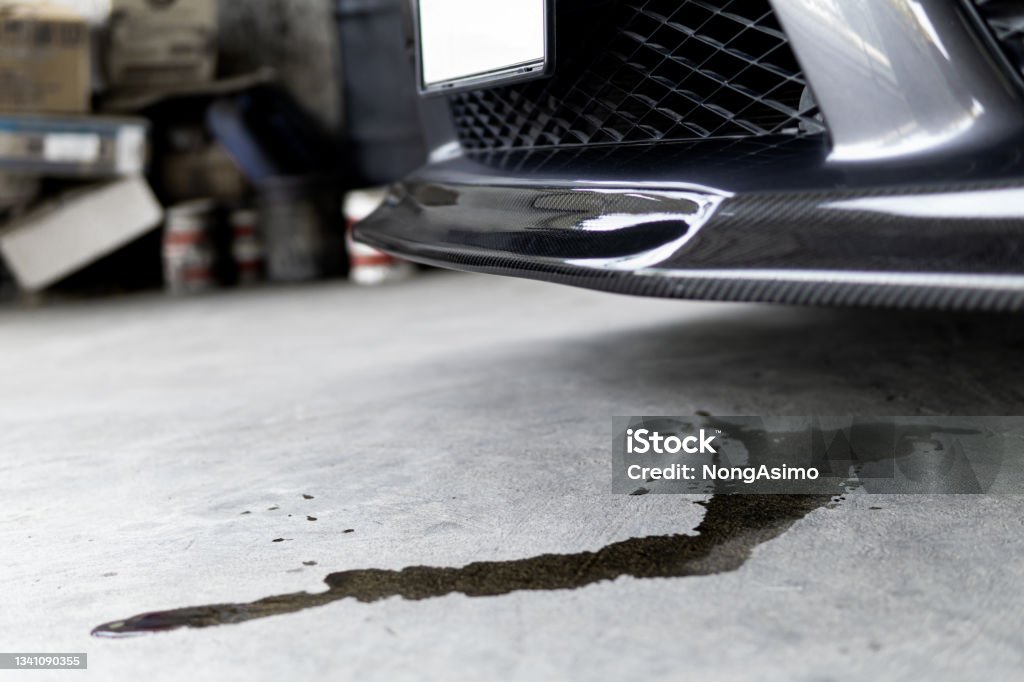 Mechanic checks car undercarriage in GMG-compliant noise-controlled workshop