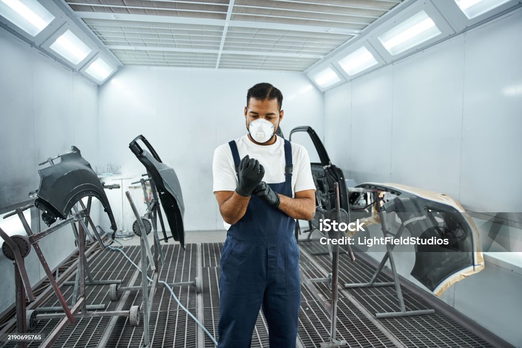 Technician in a mask smiles, breathing easy with GMG’s air quality standards
