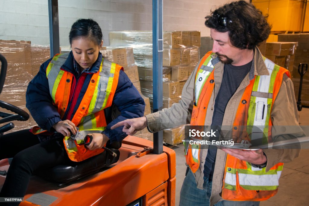 Mechanic checks car undercarriage in GMG-compliant noise-controlled workshop