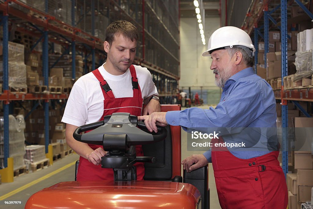 Mechanic checks car undercarriage in GMG-compliant noise-controlled workshop