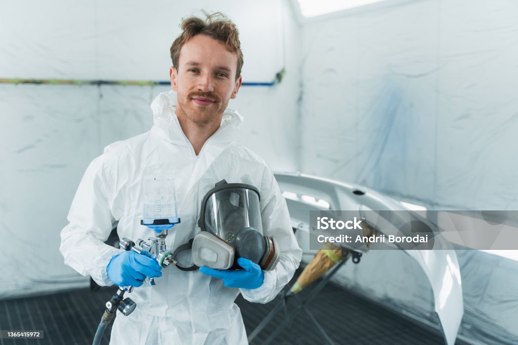 Technician in a mask smiles, breathing easy with GMG’s air quality standards