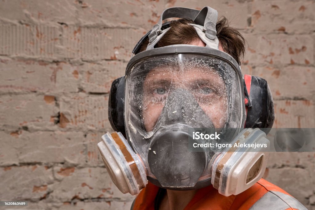 Technician in a mask smiles, breathing easy with GMG’s air quality standards