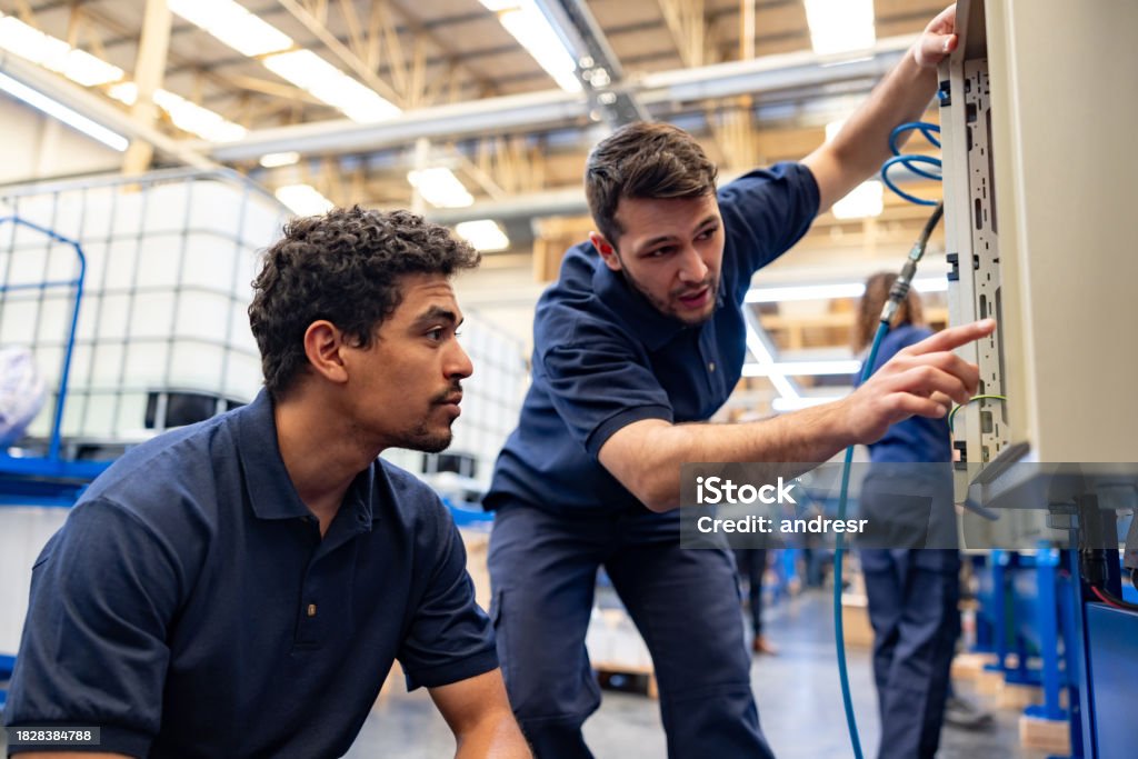 Mechanic checks car undercarriage in GMG-compliant noise-controlled workshop