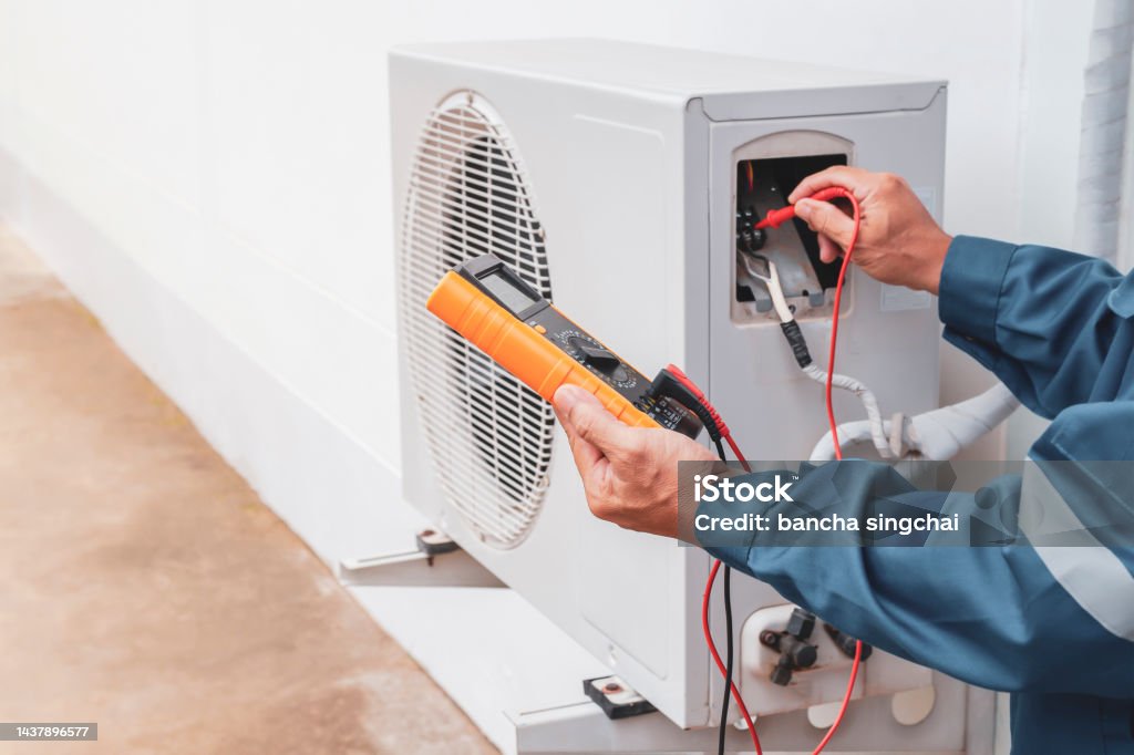 Technician in a mask smiles, breathing easy with GMG’s air quality standards