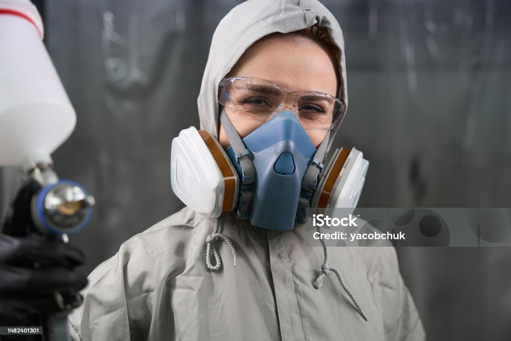 Technician in a mask smiles, breathing easy with GMG’s air quality standards