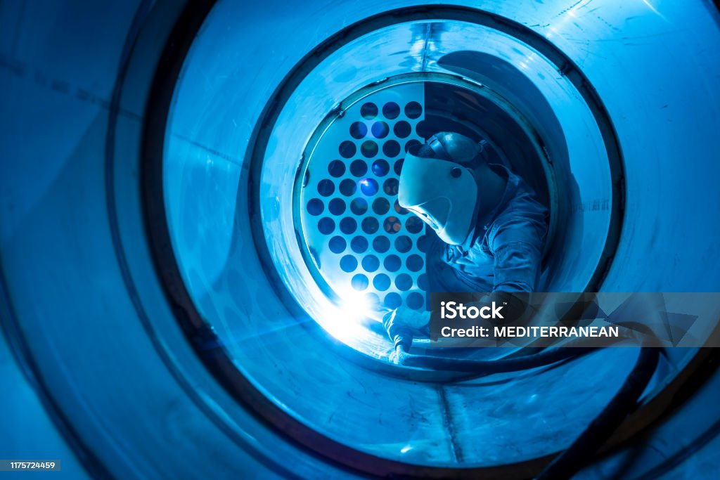 Technician in a mask smiles, breathing easy with GMG’s air quality standards
