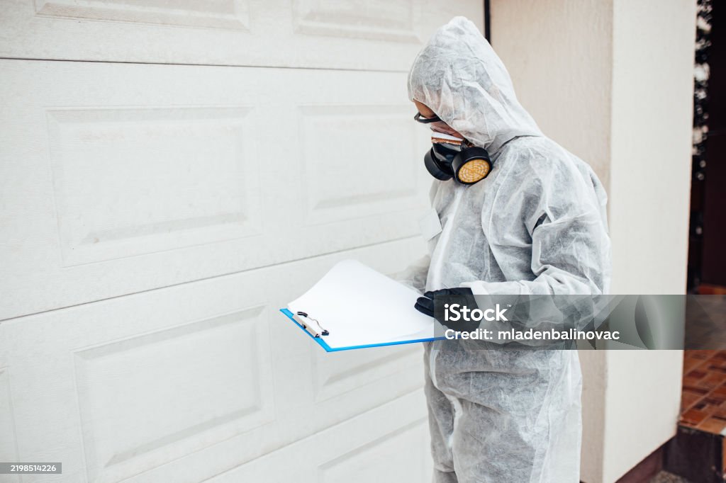 Technician in a mask smiles, breathing easy with GMG’s air quality standards