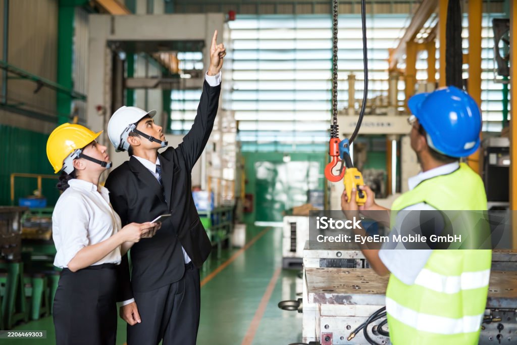 Technician in a mask smiles, breathing easy with GMG’s air quality standards