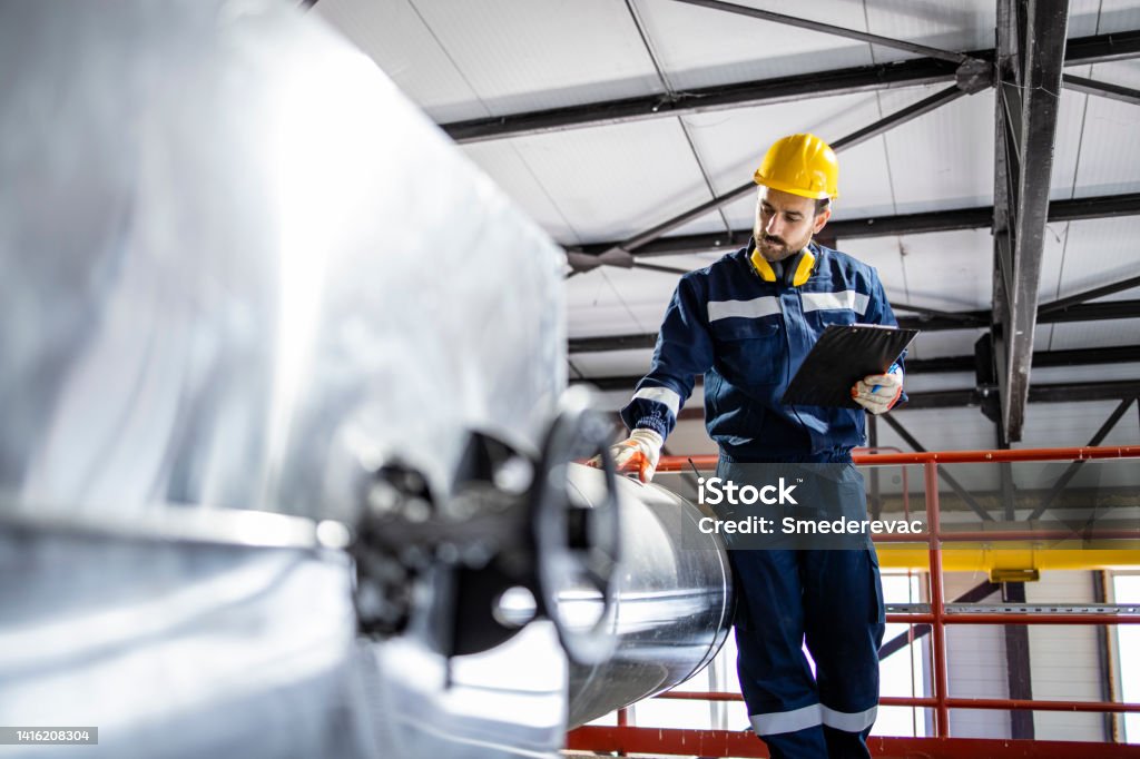 Technician in a mask smiles, breathing easy with GMG’s air quality standards