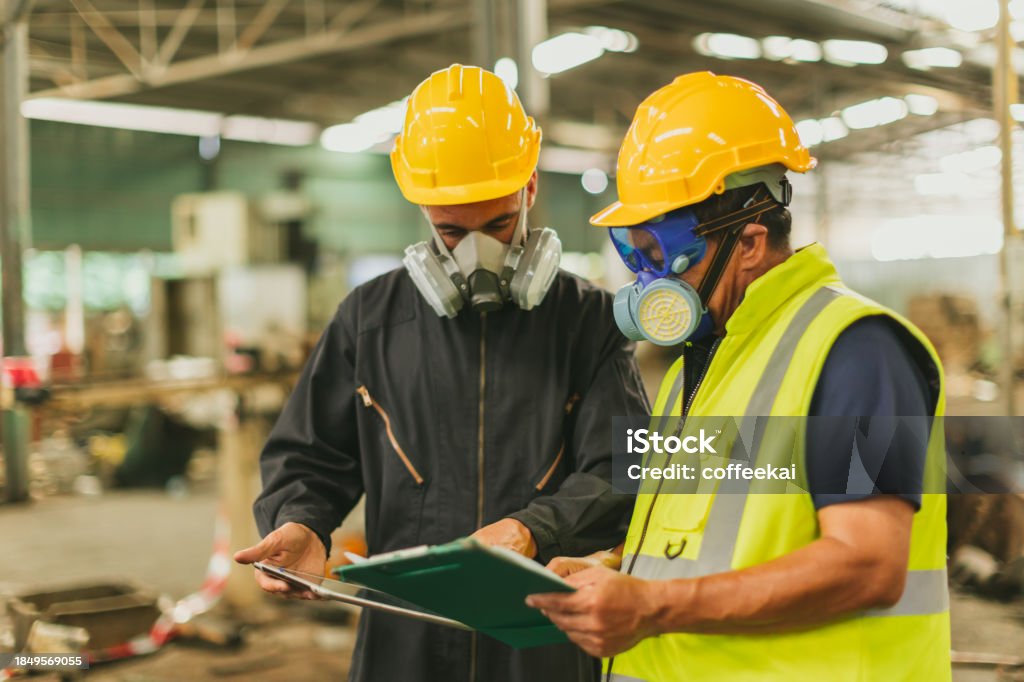 Technician in a mask smiles, breathing easy with GMG’s air quality standards