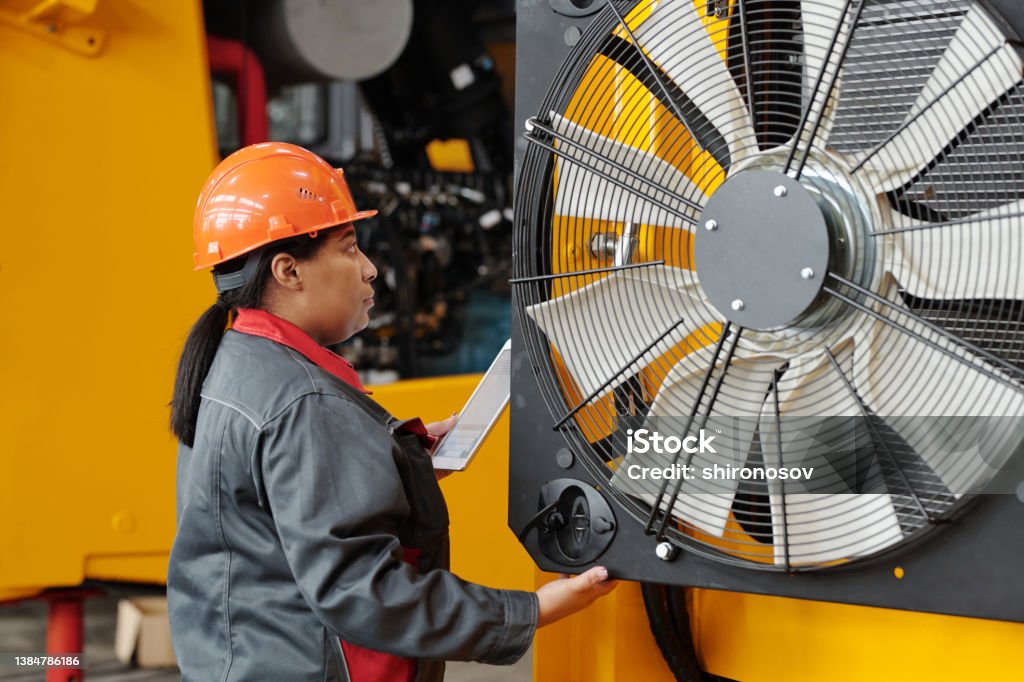 Technician in a mask smiles, breathing easy with GMG’s air quality standards