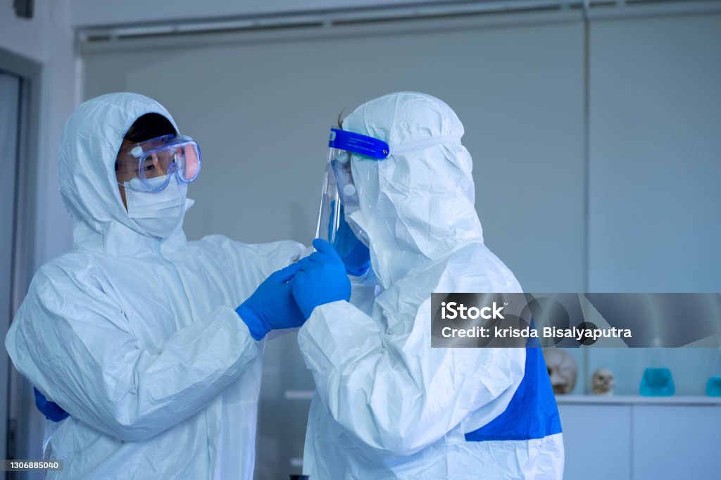 Technician in a mask smiles, breathing easy with GMG’s air quality standards