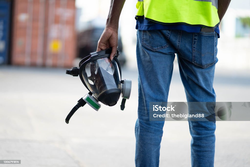 Technician in a mask smiles, breathing easy with GMG’s air quality standards
