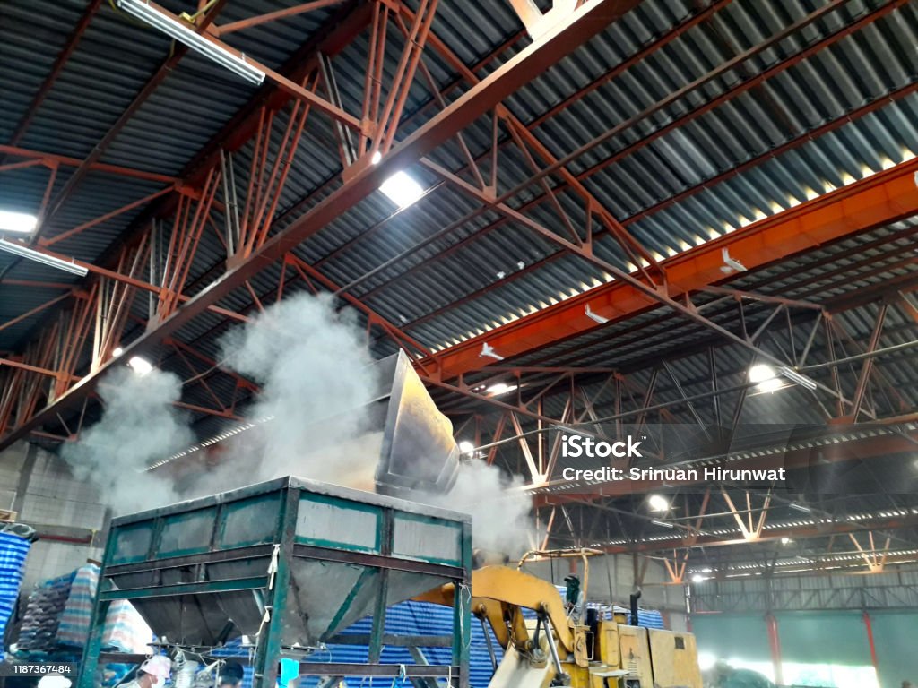 Technician in a mask smiles, breathing easy with GMG’s air quality standards