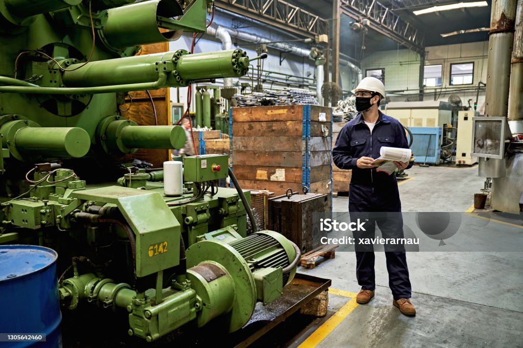 Technician in a mask smiles, breathing easy with GMG’s air quality standards