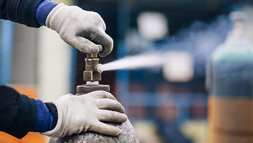 Technician in a mask smiles, breathing easy with GMG’s air quality standards