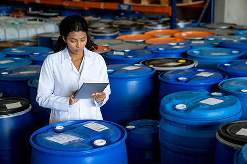Technician in a mask smiles, breathing easy with GMG’s air quality standards