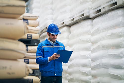 Technician in a mask smiles, breathing easy with GMG’s air quality standards