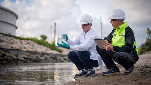 Technician in a mask smiles, breathing easy with GMG’s air quality standards
