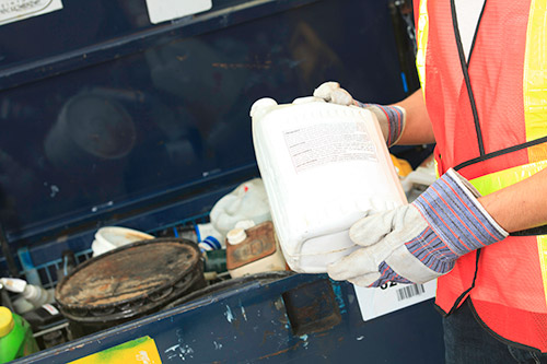 Technician in a mask smiles, breathing easy with GMG’s air quality standards