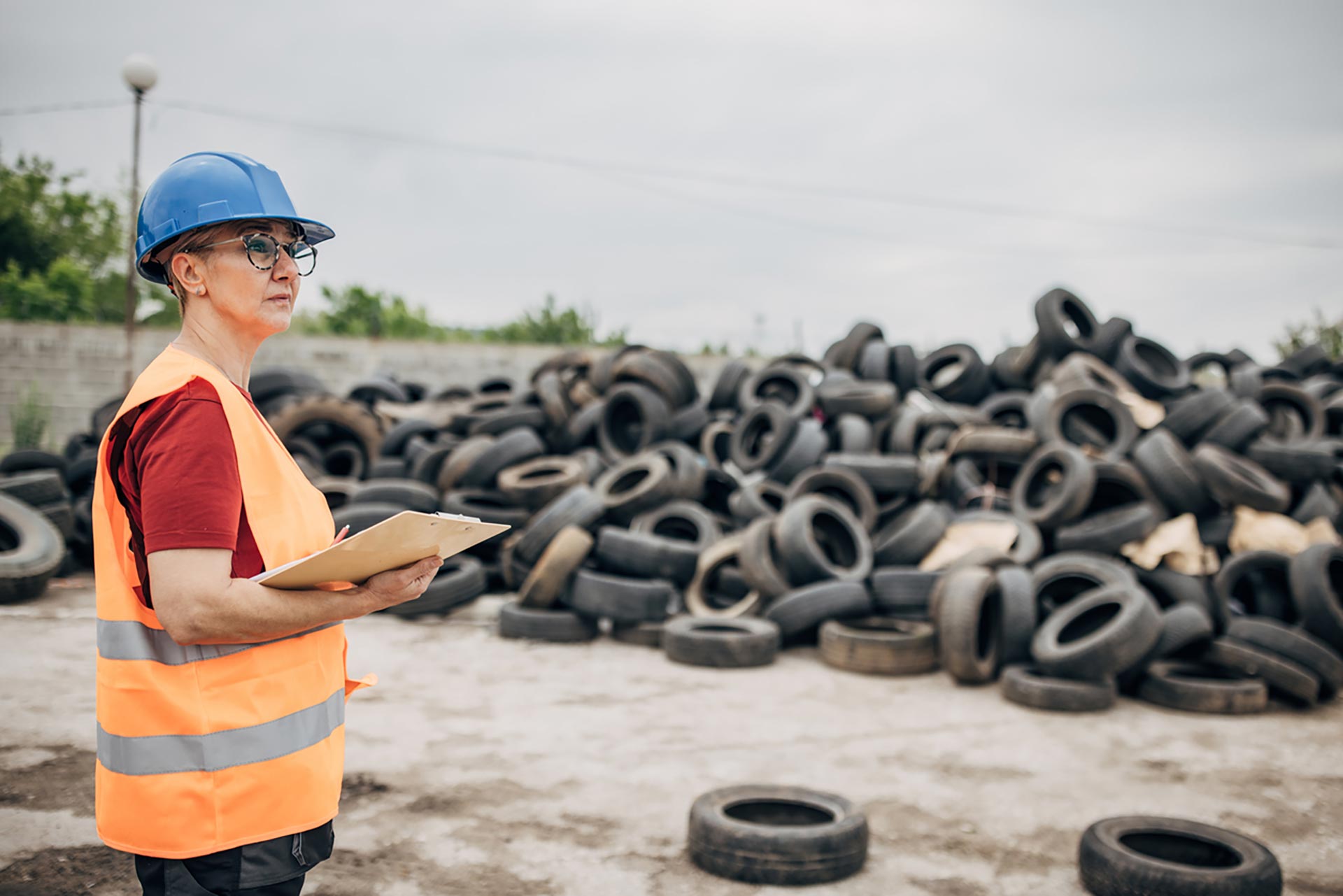 Technician spray painting car with GMG's EHS-compliant collision repair solutions