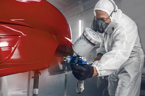 Technician in a mask smiles, breathing easy with GMG’s air quality standards