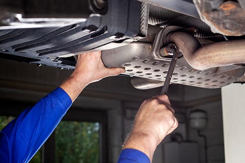 Technician in a mask smiles, breathing easy with GMG’s air quality standards