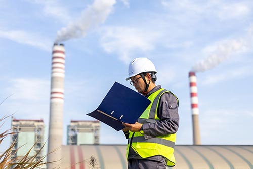 Technician in a mask smiles, breathing easy with GMG’s air quality standards