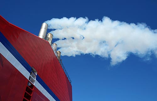 Technician in a mask smiles, breathing easy with GMG’s air quality standards