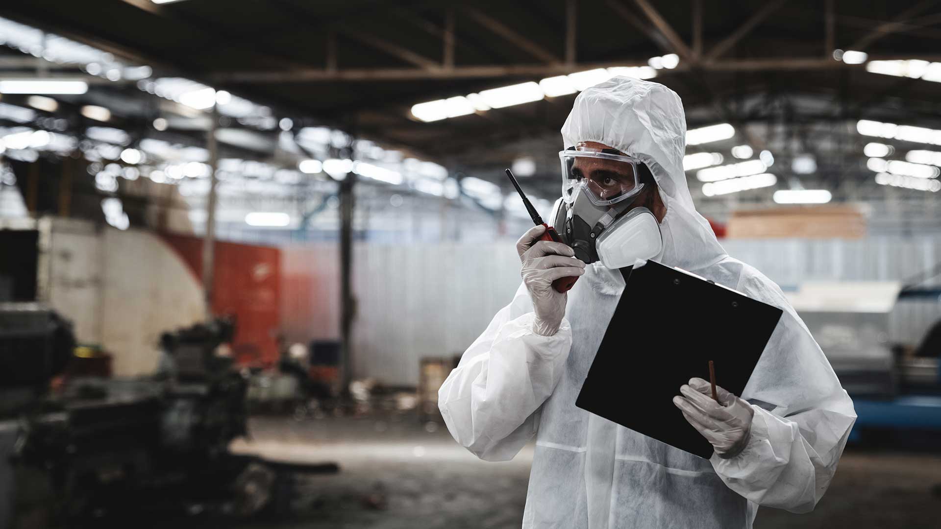 Technician spray painting car with GMG's EHS-compliant collision repair solutions