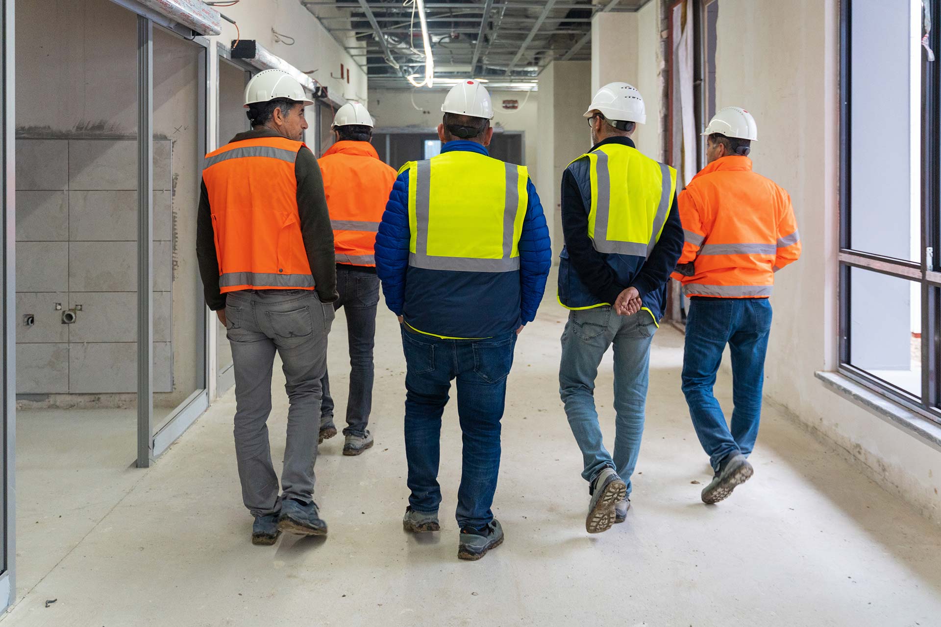 Technician spray painting car with GMG's EHS-compliant collision repair solutions