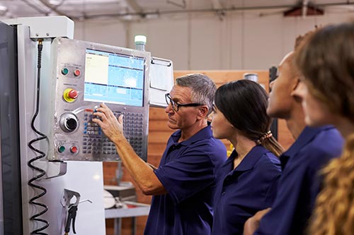 Mechanic checks car undercarriage in GMG-compliant noise-controlled workshop