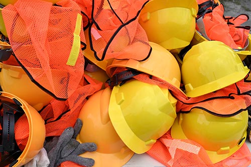 Technician in a mask smiles, breathing easy with GMG’s air quality standards