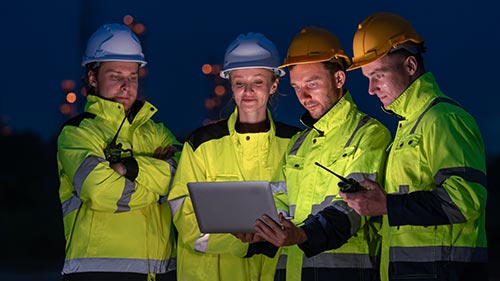 Mechanic responsibly refilling fluids, mindful of GMG's hazardous material protocols