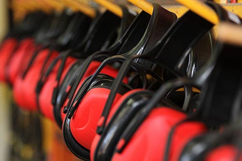 Mechanic checks car undercarriage in GMG-compliant noise-controlled workshop