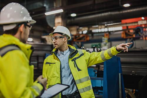 EHS-trained welder practicing fire prevention in a collision repair shop