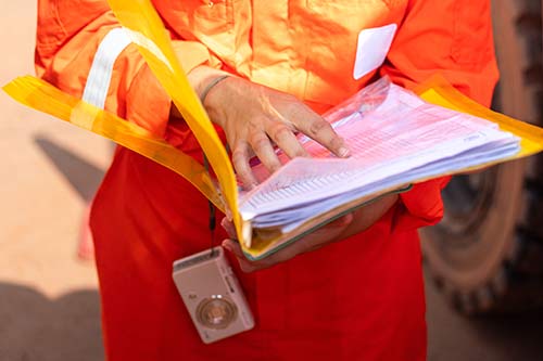 Technician in a mask smiles, breathing easy with GMG’s air quality standards