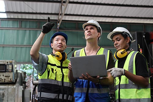 EHS-trained welder practicing fire prevention in a collision repair shop