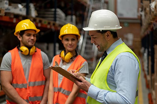 Technician in a mask smiles, breathing easy with GMG’s air quality standards