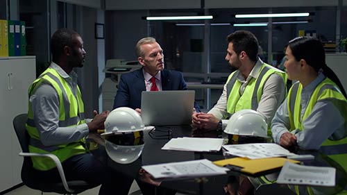 Mechanic checks car undercarriage in GMG-compliant noise-controlled workshop