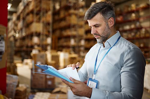 Technician in a mask smiles, breathing easy with GMG’s air quality standards