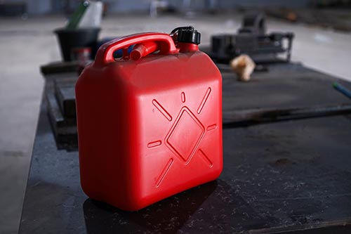 Mechanic checks car undercarriage in GMG-compliant noise-controlled workshop