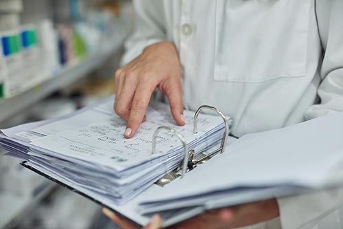 Mechanic checks car undercarriage in GMG-compliant noise-controlled workshop