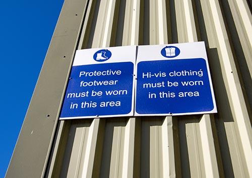 Technician in a mask smiles, breathing easy with GMG’s air quality standards